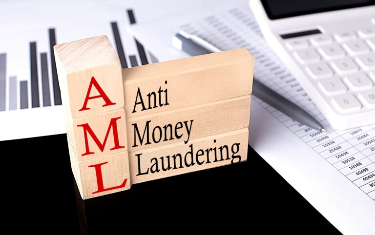 Wooden blocks spelling AML (Anti Money Laundering).