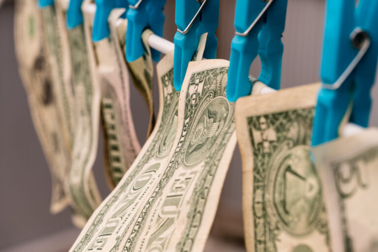 U.S dollar bills clipped to a dry line, representing money laundering.